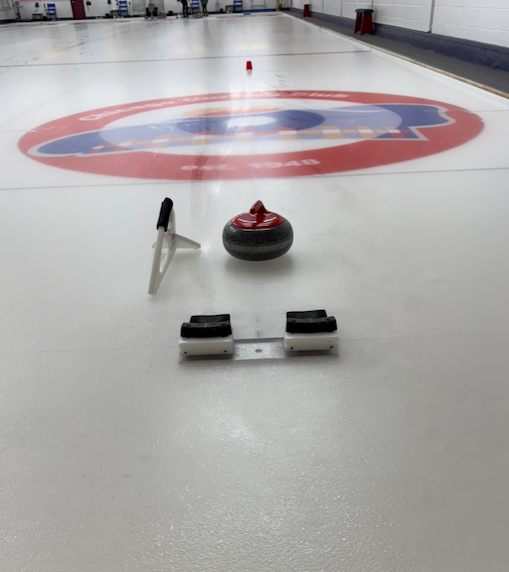 Shot of the curling ice, stone and stabilizer.